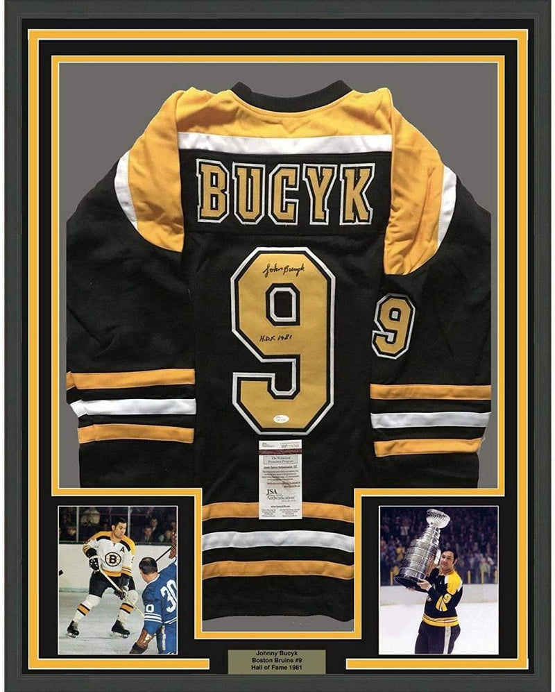 Framed Autographed/Signed John Johnny Bucyk HOF 1981 35x39 Boston Black Hockey Jersey JSA COA